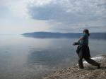 Drew skims stones on the flat calm of Lake Baikal